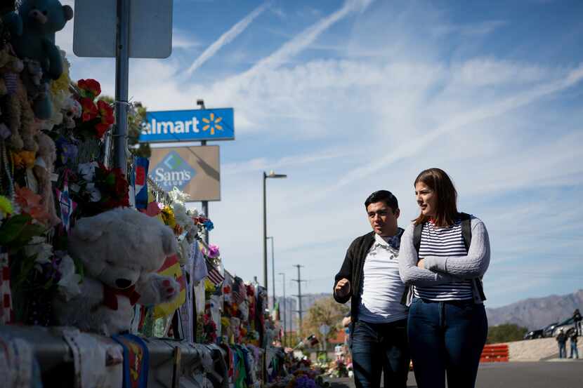 Gaddiel Antonio and Diana Castaneda, from Juarez, Mexico, visit the memorial that honors...