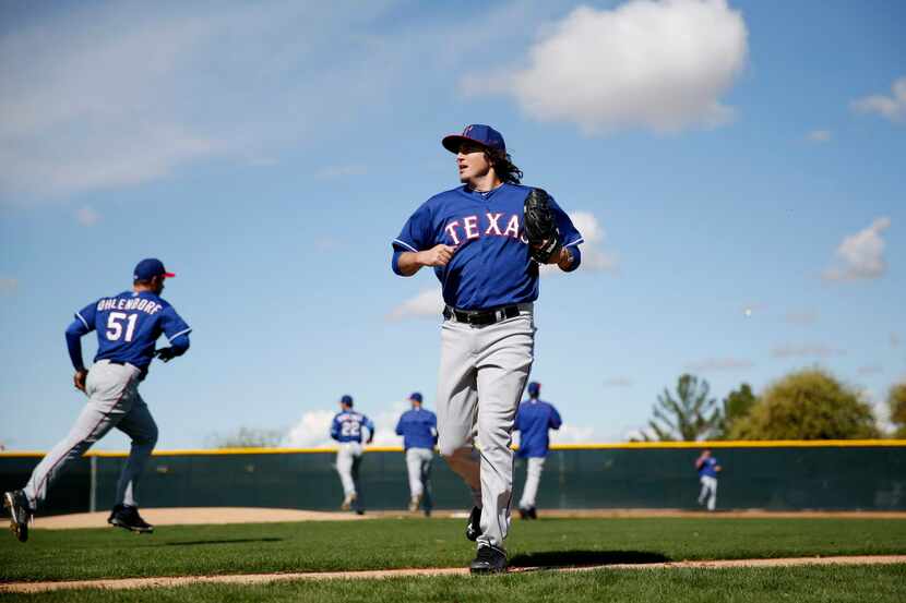 Texas Rangers pitcher Luke Jackson runs off the field while participating in a mock game...