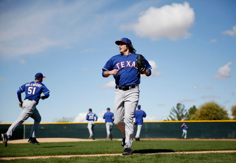 Texas Rangers pitcher Luke Jackson runs off the field while participating in a mock game...