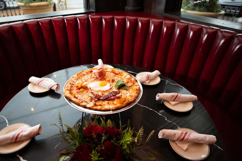 Sfuzzi’s breakfast pizza is topped with sunny side egg, bacon, cherry tomato, 24-month aged...
