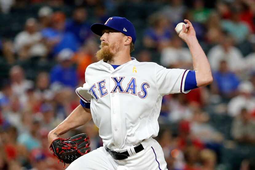 Texas Rangers relief pitcher Jake Diekman throws to the Los Angeles Angels in the seventh...