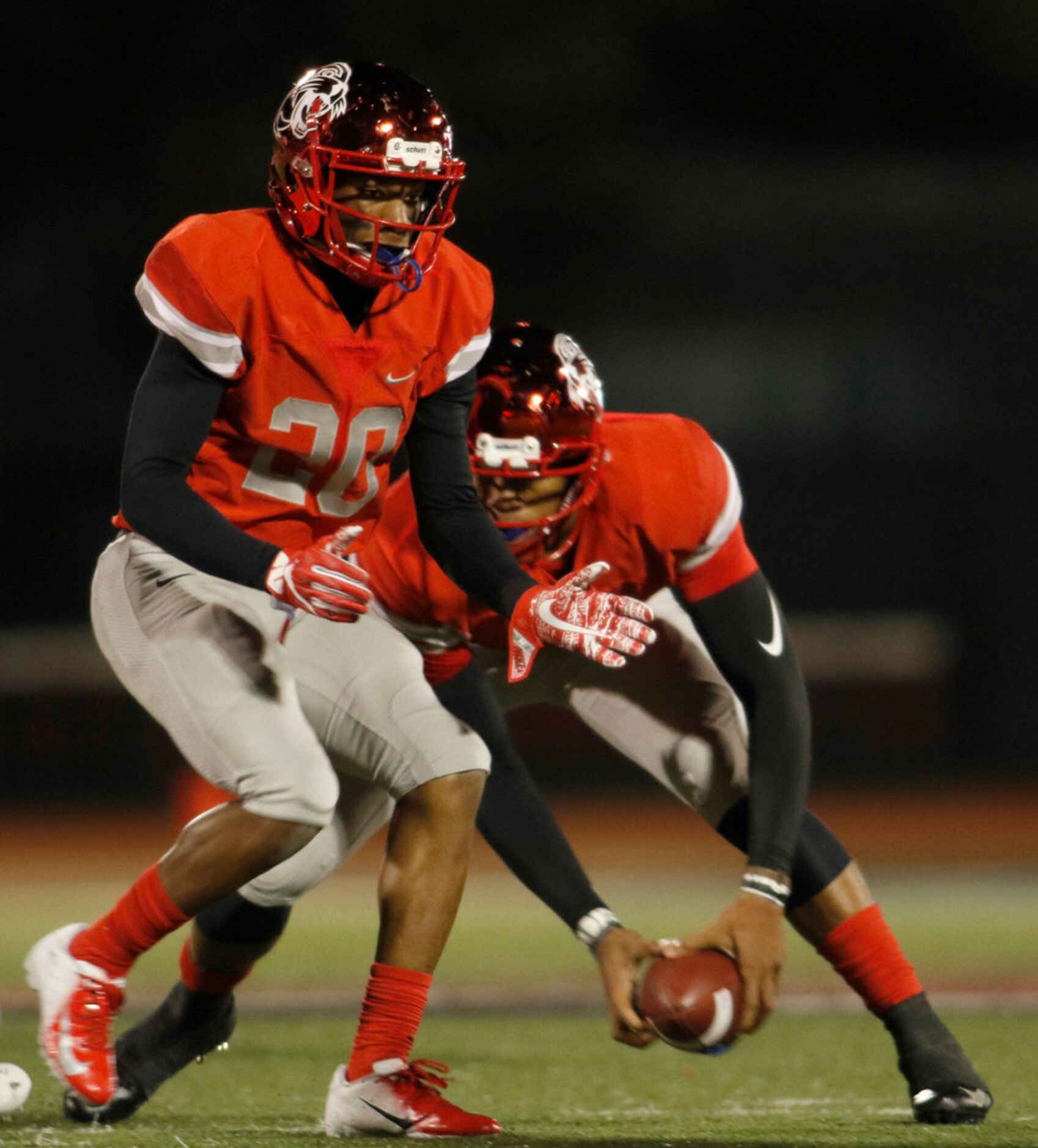 Duncanville quarterback Ja'Quinden Jackson (3) retrieves a low snap from center as running...