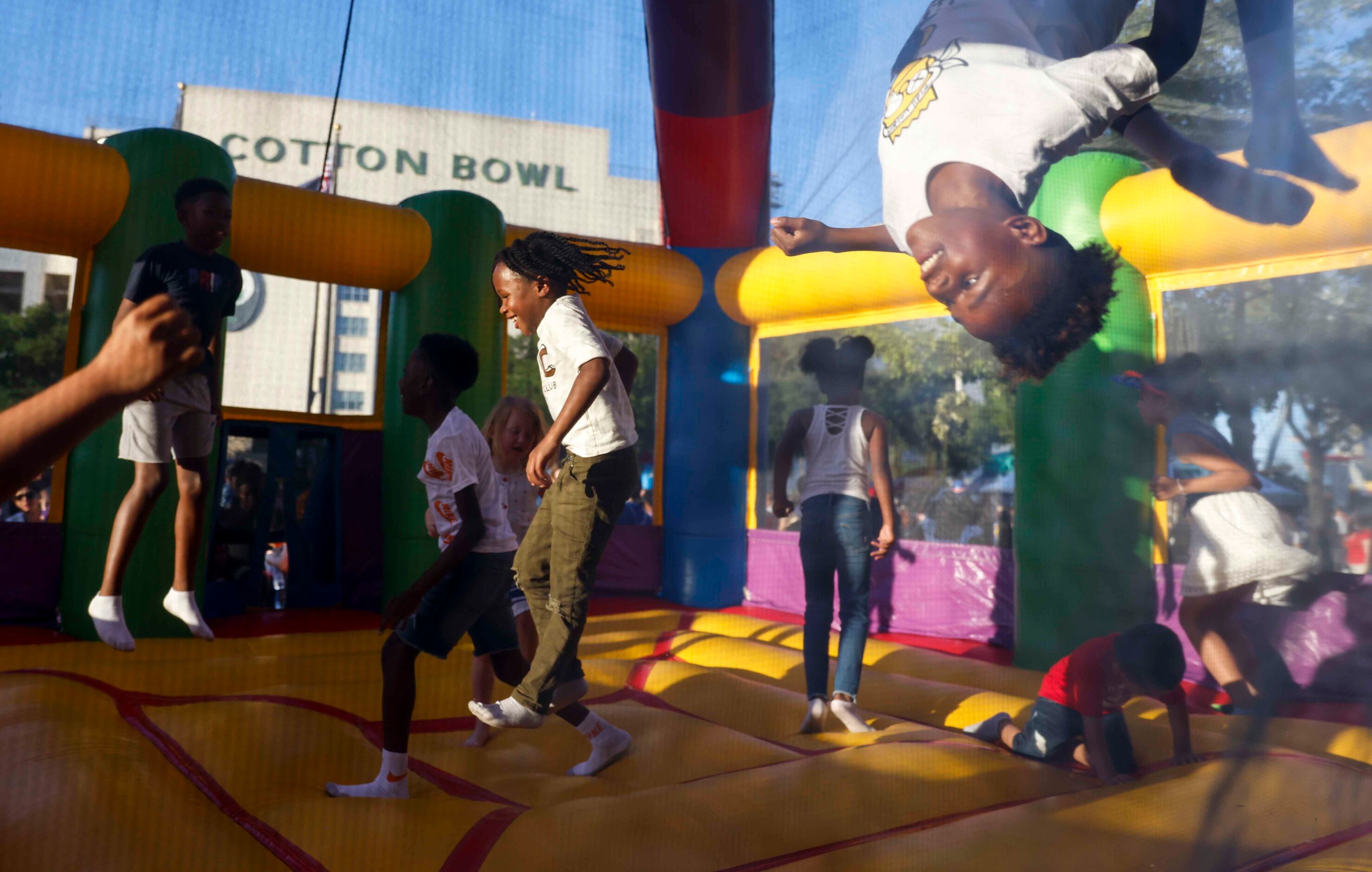 Kids enjoy their time in jumping house during an Independence Day celebration on Monday,...