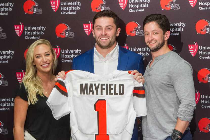 Cleveland Browns first-round draft  pick Baker Mayfield, center, stands with his girlfriend,...