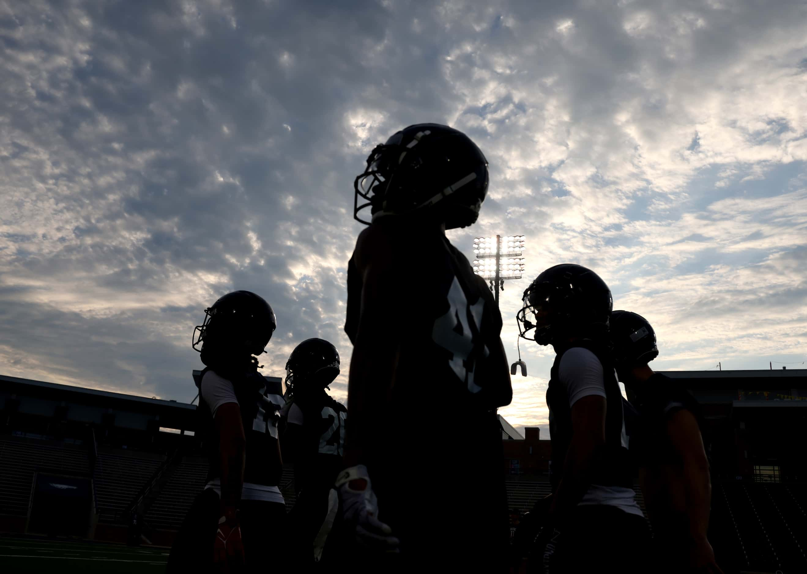 A group of Allen Eagles defensive backs follow an assistant coach to relocate for a new...