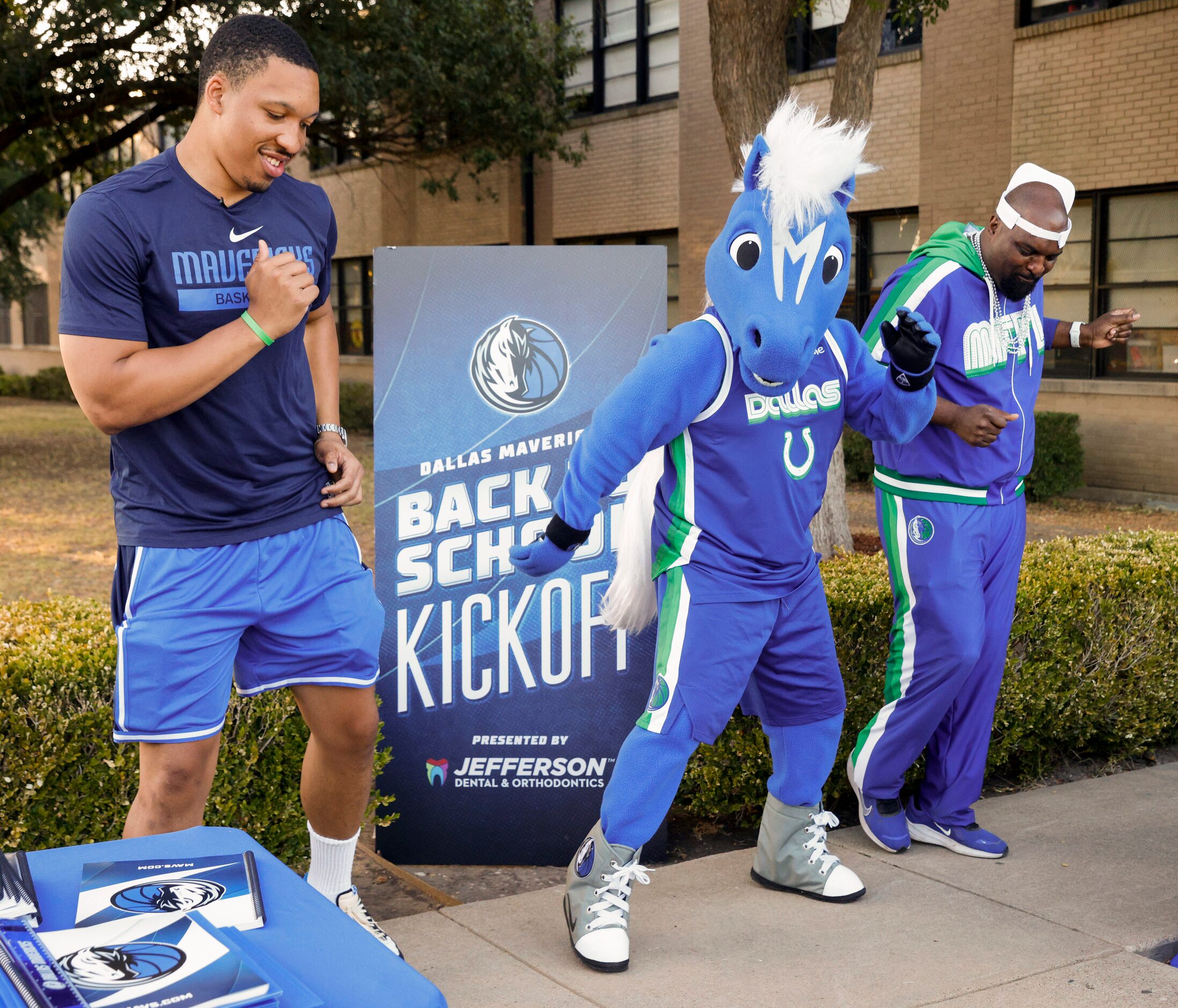 Dallas Mavericks forward Grant Williams (left), Mavs mascot Champ (center) and Mavs...