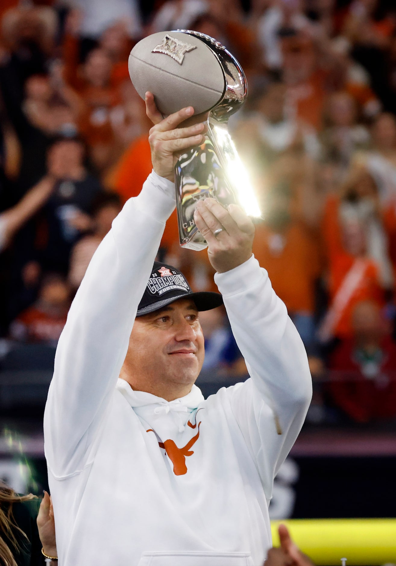 Texas Longhorns head coach Steve Sarkisian hosts the Big XII Championship trophy after...