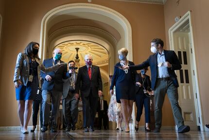 Senate Majority Leader Mitch McConnell (R-KY) is swarmed by reporters as he leaves the...