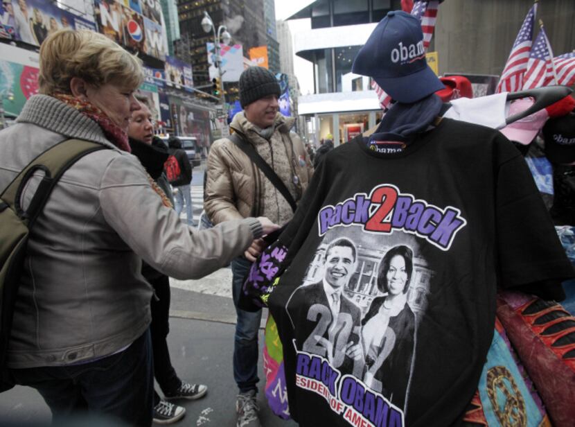 Tourists look at Obama memorabilia at a street vendor's table in New York's Times Square on...