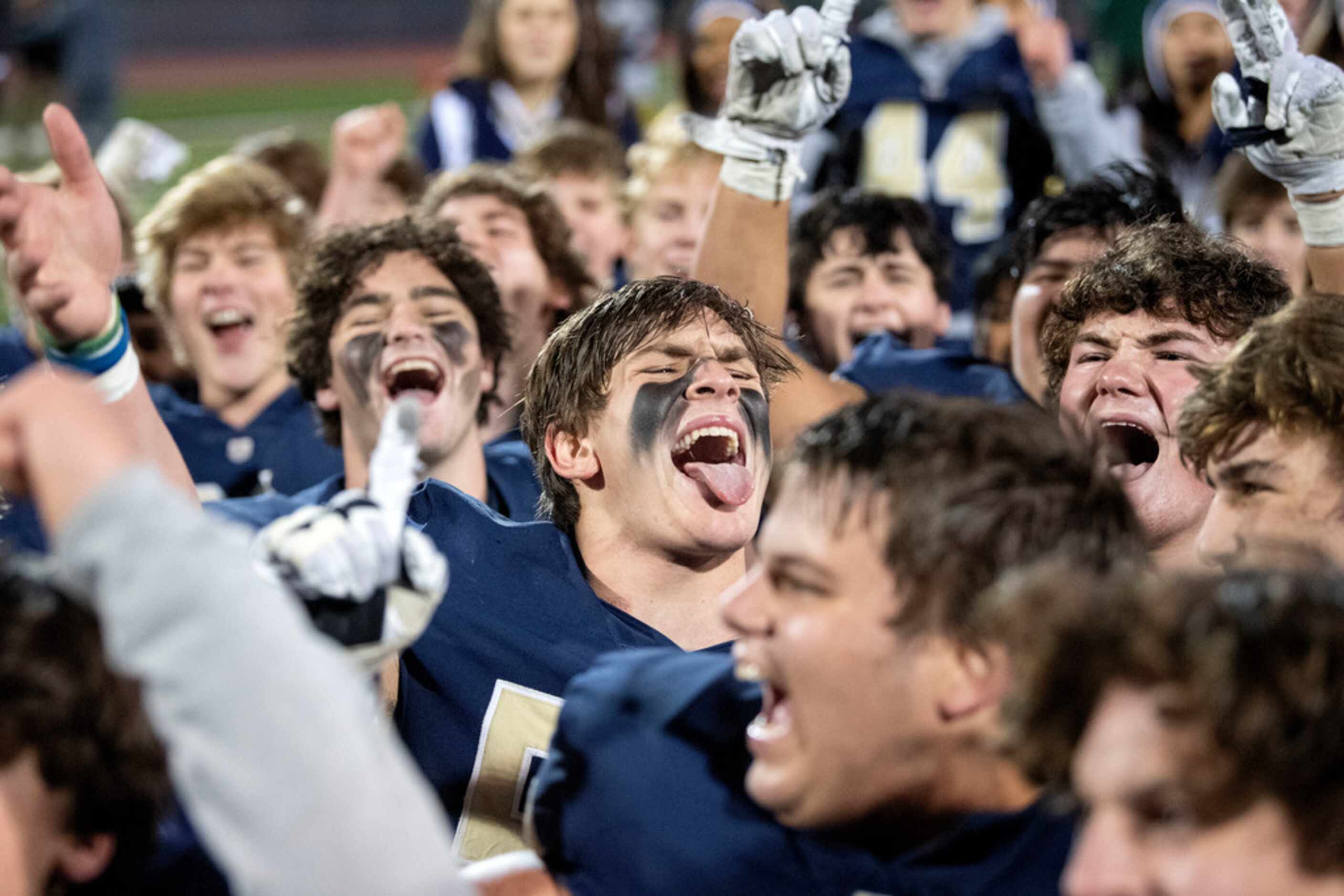 Jesuit senior linebacker Tommy Roy (55), center, cheers wildly after his team defeated...