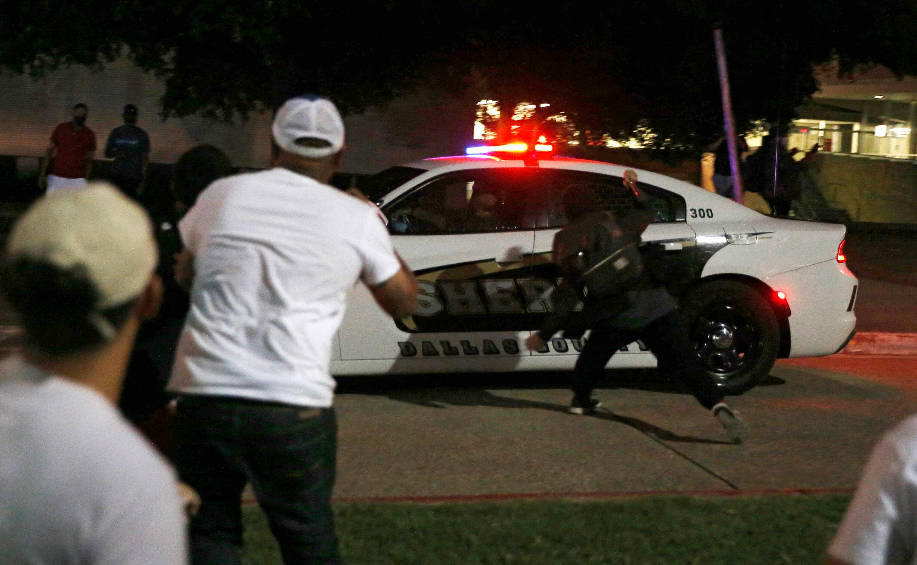 Protesters hit a Dallas County Sheriff's vehicle during a demonstration against police...