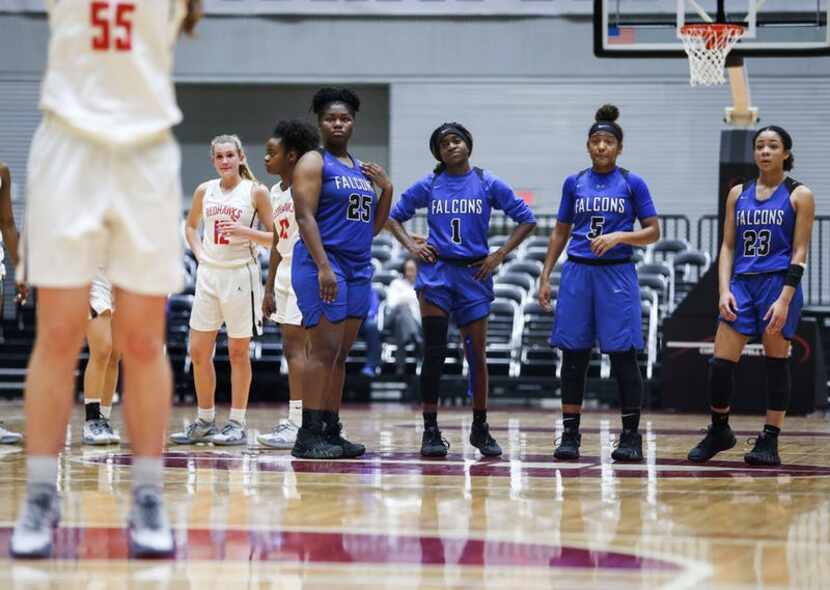 The North Forney Lady Falcons watch as Frisco Liberty's Kelsey Kurak (55) shoots a free...