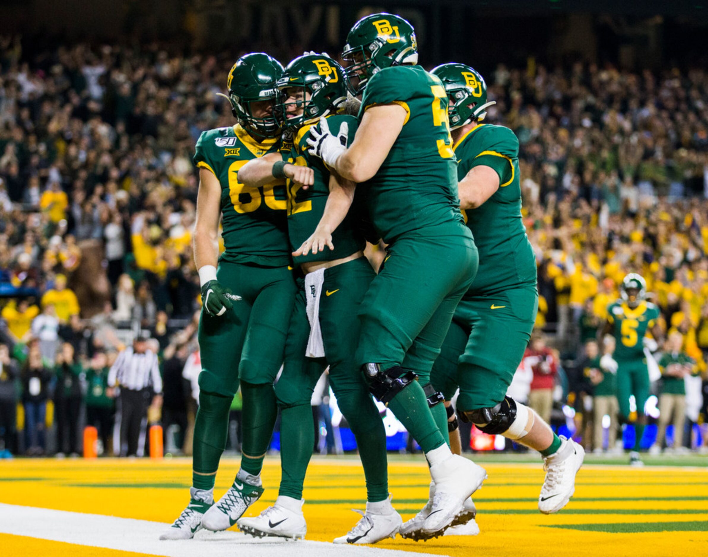 Baylor Bears quarterback Charlie Brewer (12) celebrates a touchdown with teammates during...