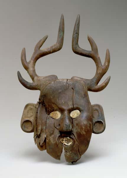 This human-face-with-deer-antlers effigy, made of wood and found in Oklahoma, dates to the...