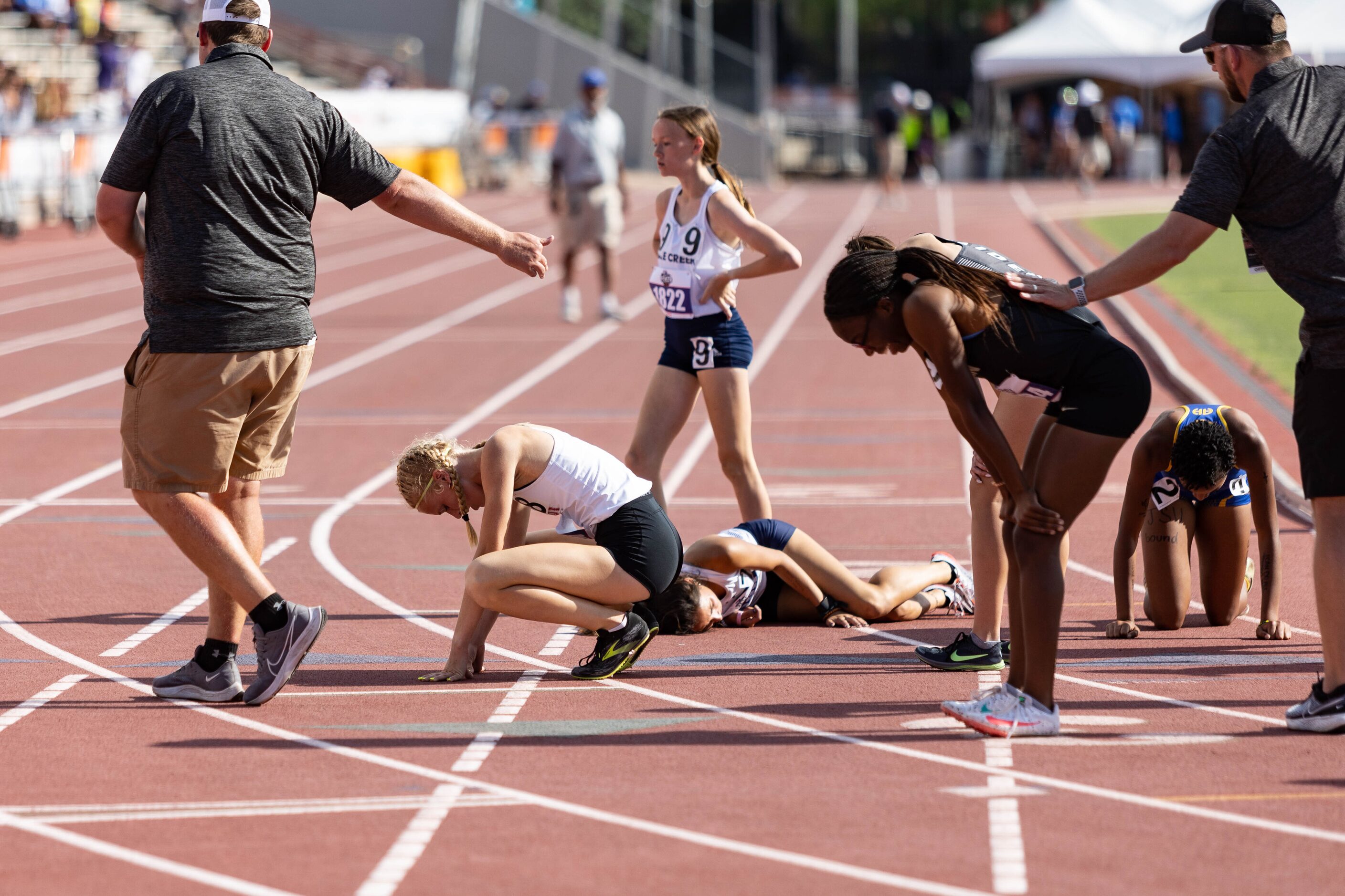 Kailey Littlefield of Lucas Lovejoy, second from the left, catches her breath after winning...