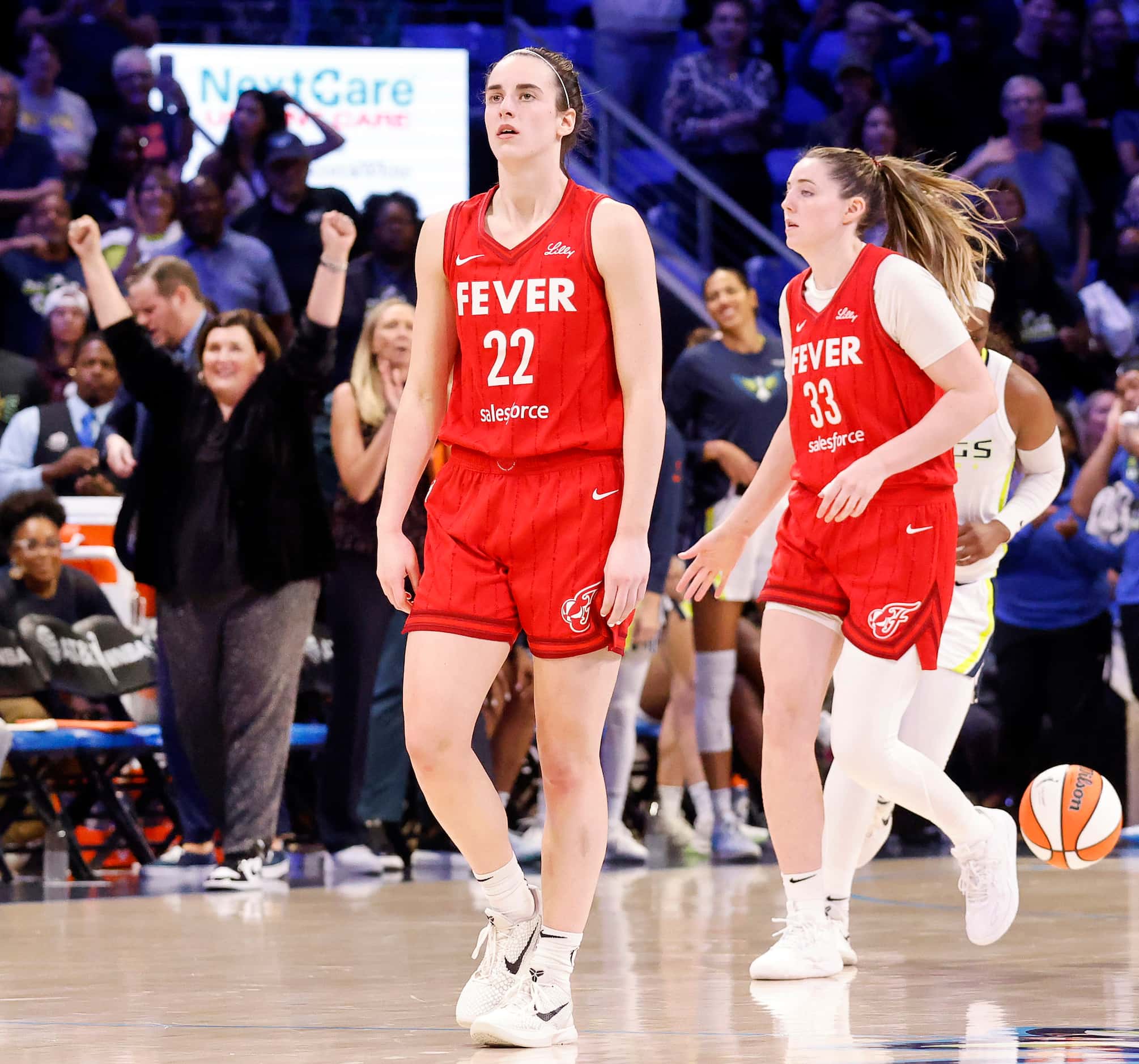 After the game-ending buzzer sounds, Indiana Fever guard Caitlin Clark (22) and forward...