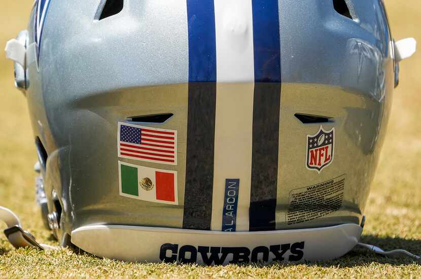 The helmet of Dallas Cowboys tackle Isaac Alarcón (60) features flags of both the United...