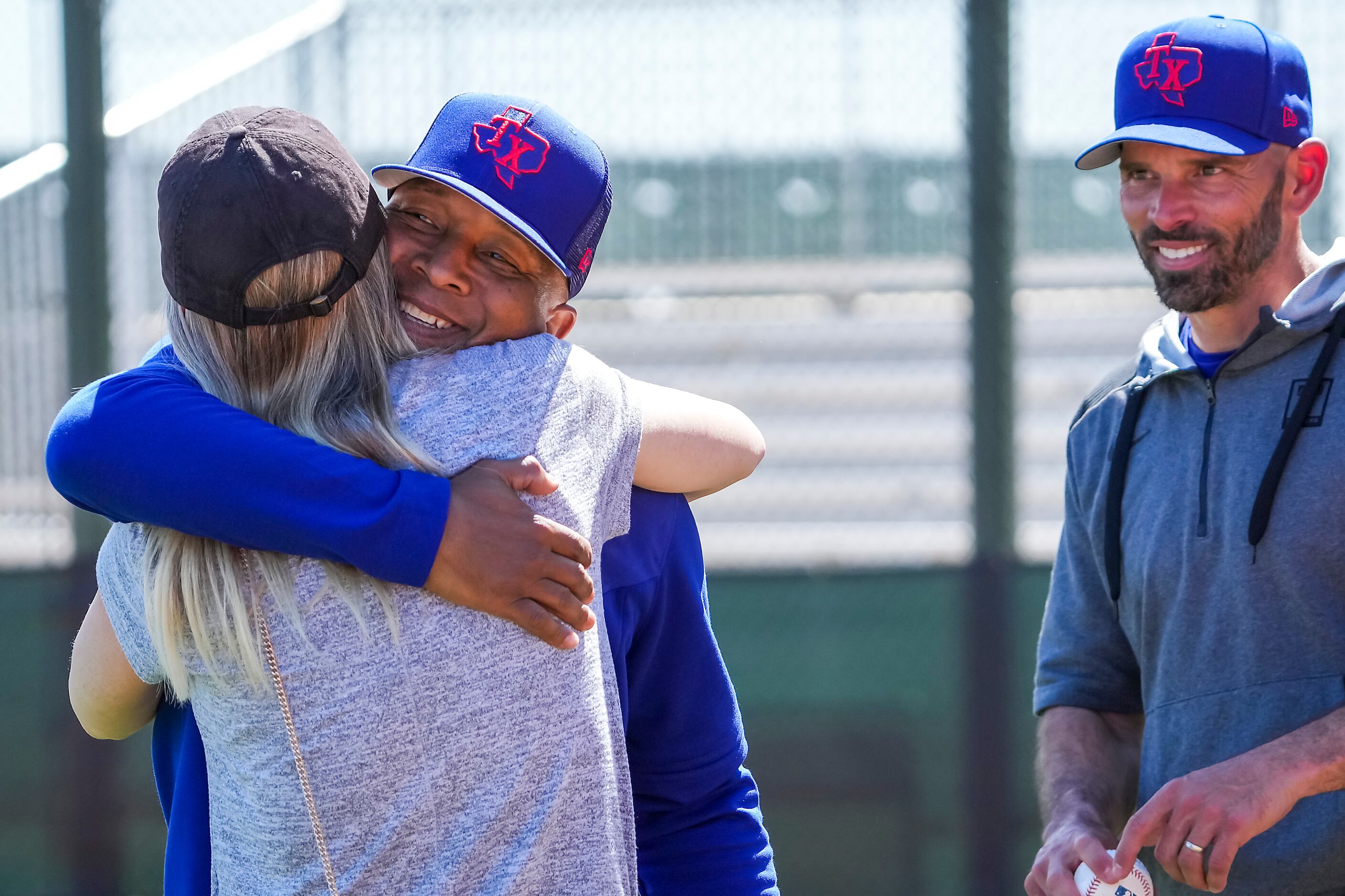 Texas Rangers third base coachTony Beasley hugs manager Chris Woodward’s wife Erin Woodward...