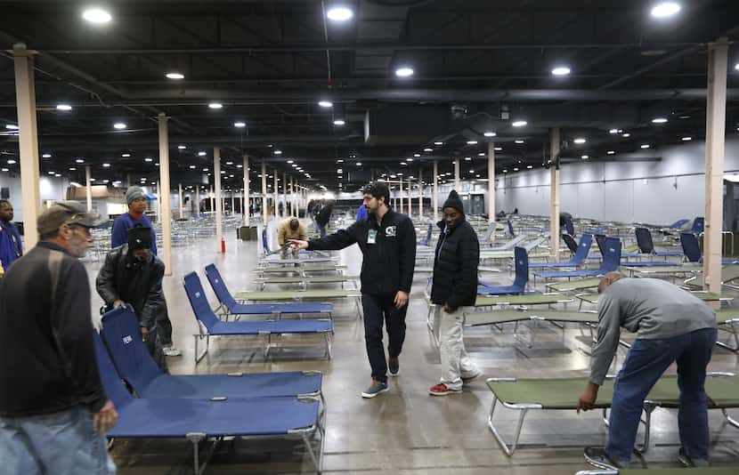 Volunteers prepared cots for those who will use the Temporary Inclement Weather Shelter at...