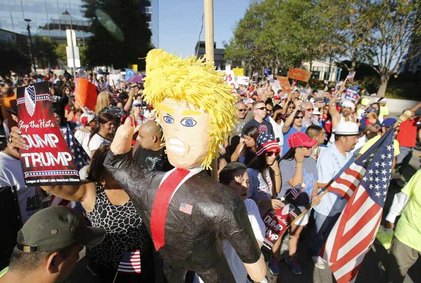  Protesters hoisted a Donald Trump piÃ±ata during a march last September to American...
