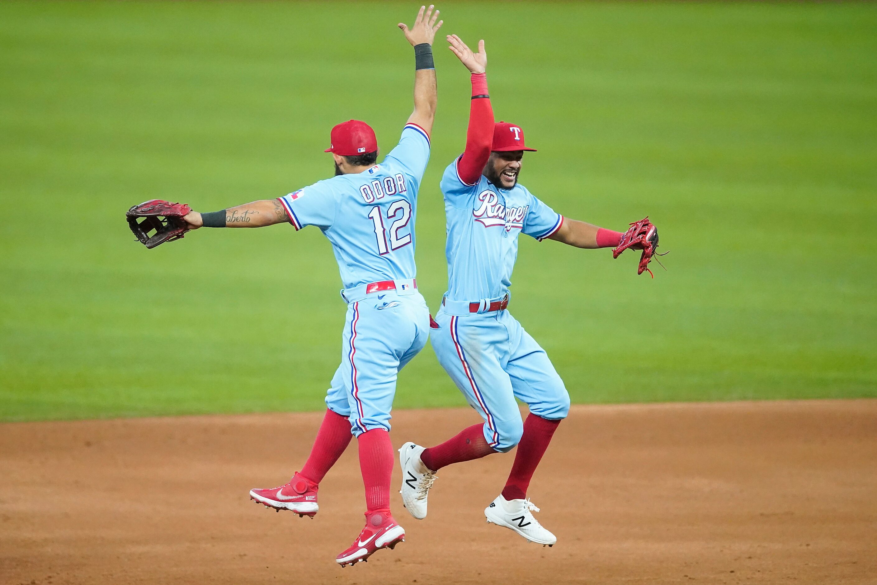 Texas Rangers second baseman Rougned Odor celebrates with center fielder Leody Taveras after...