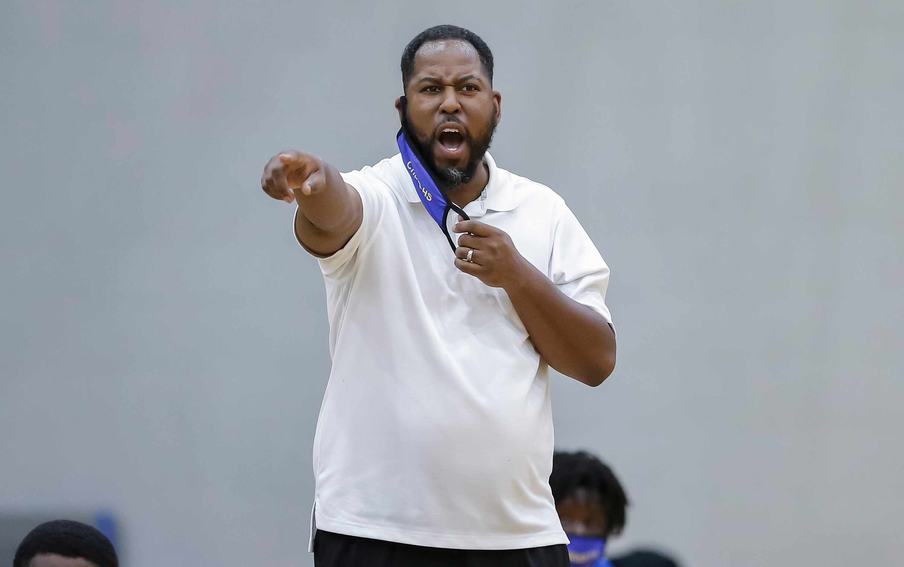 Conrad coach Aubreion Wright shouts instructions to his players during a high school...