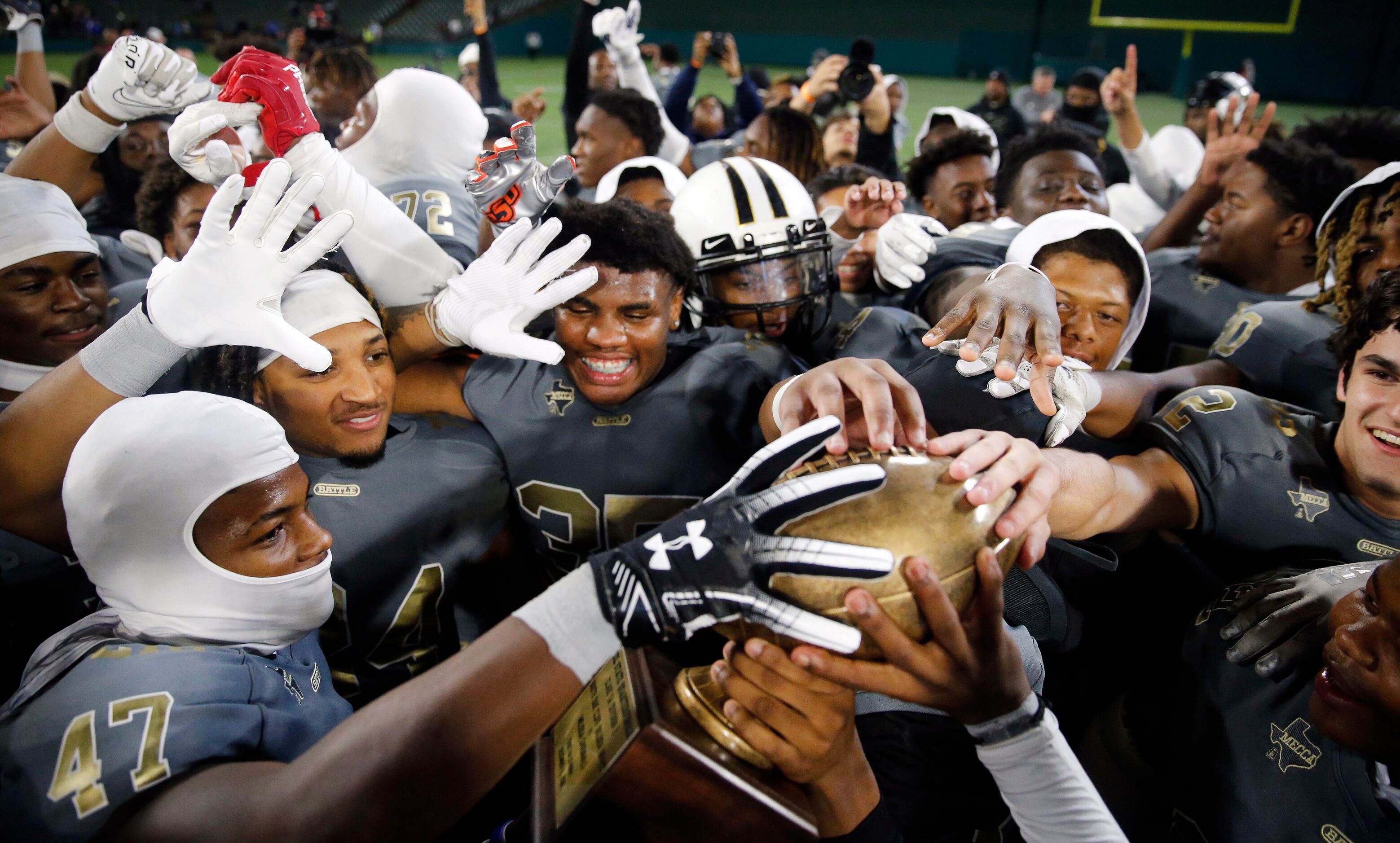 South Oak Cliff football players celebrate their Class 5A Division II Region II final win...