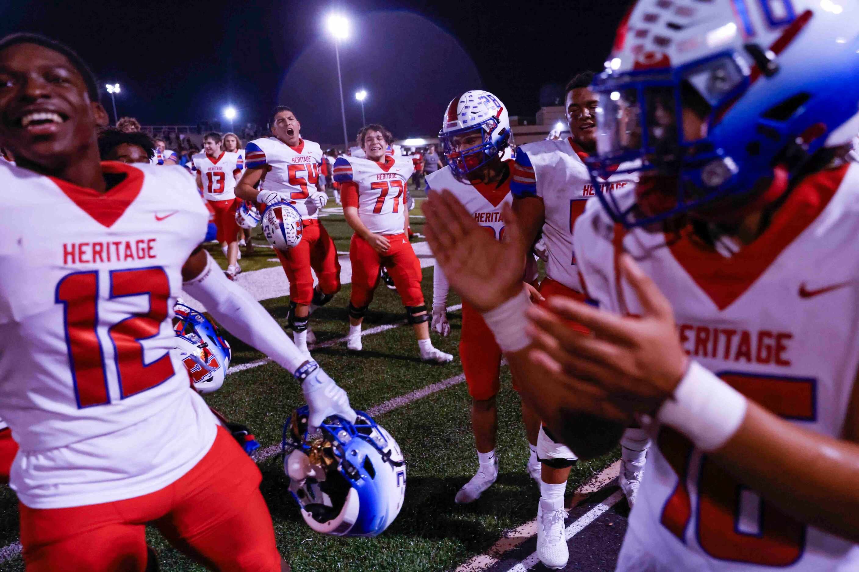 Midlothian Heritage high players celebrate after winning the district 5-5A division II title...