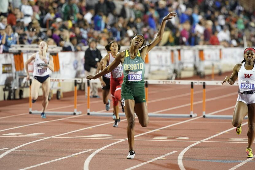 DeSoto's Taylor Armstrong (1289) flails her arms in victory at the finish line of the girls...