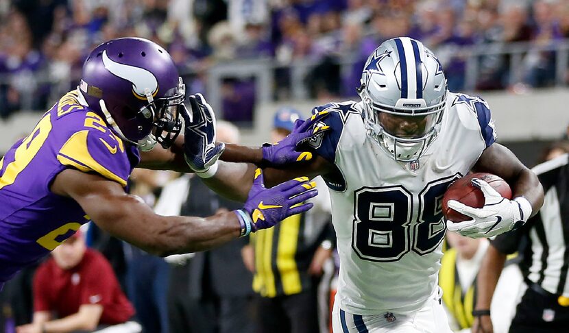 Dallas Cowboys wide receiver Dez Bryant (88) stiff arms Minnesota Vikings cornerback Xavier...