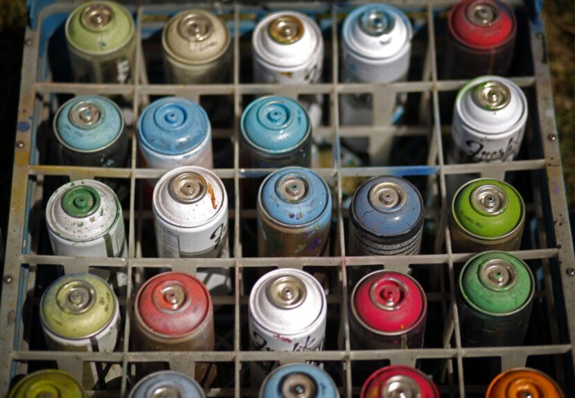 Cans of uncapped spray paint were part of the artists' palette for Saturday's initial...