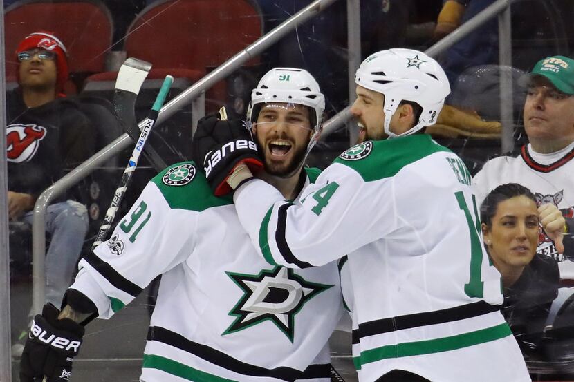 NEWARK, NJ - MARCH 26: Tyler Seguin #91 of the Dallas Stars scores at 20 seconds of overtime...