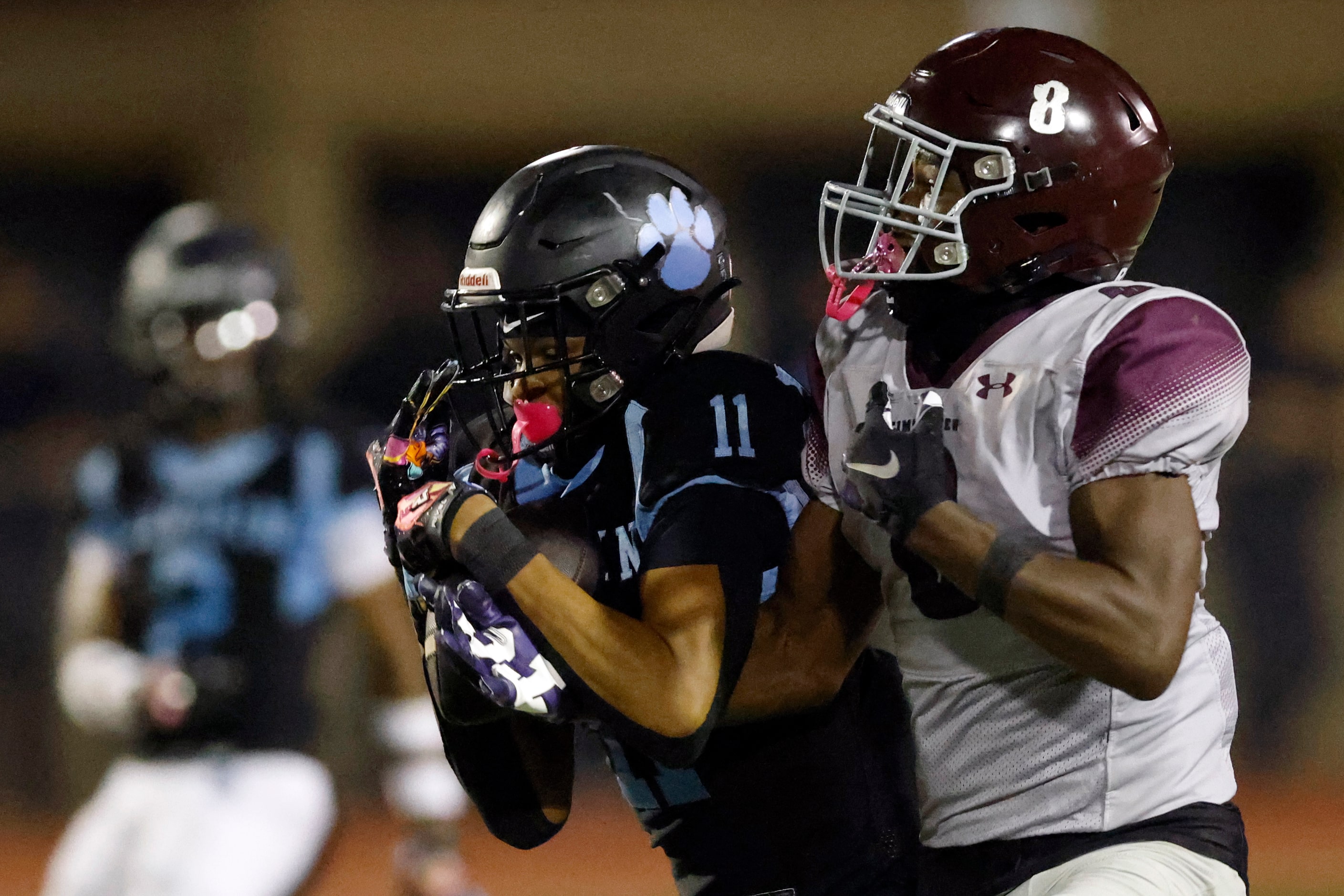 Arlington Seguin wide receiver Carterrious Brown (11) hauls in a pass ahead of Mansfield...