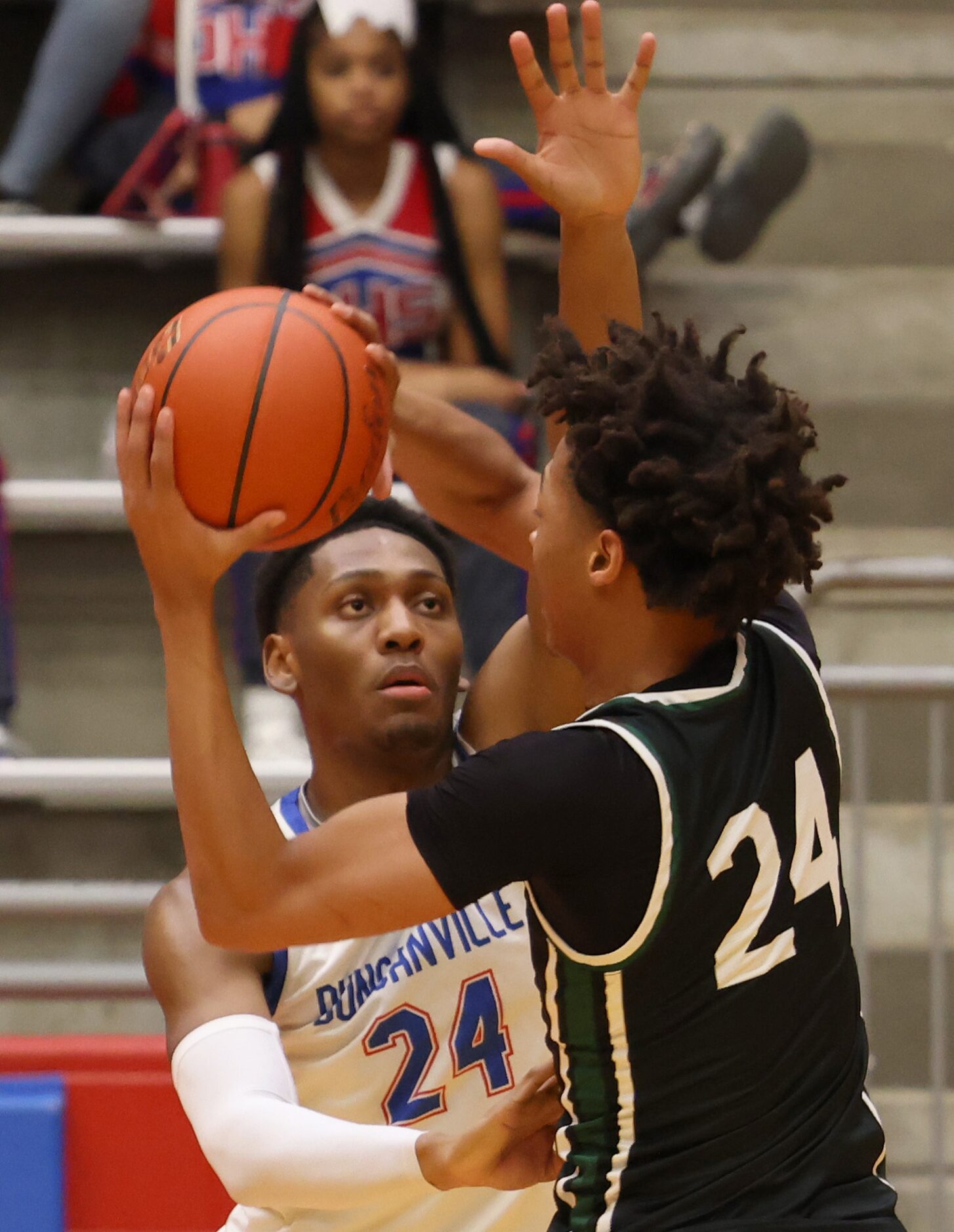 Duncanville forward Anthony Cook (24), background, eyes DeSoto forward Tymere Singleton (24)...