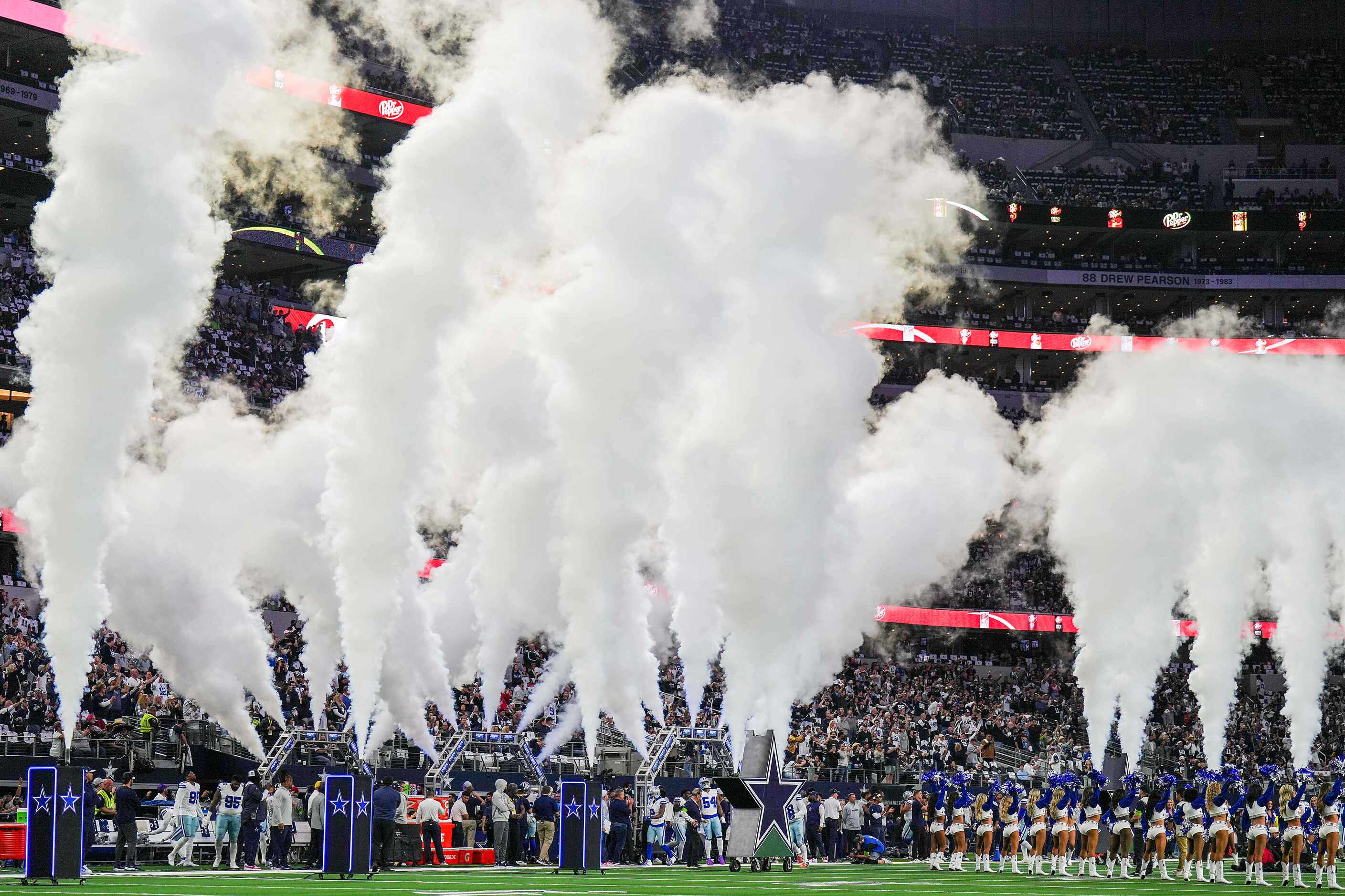 Dallas Cowboys players take the field before an NFL football game against the Seattle...
