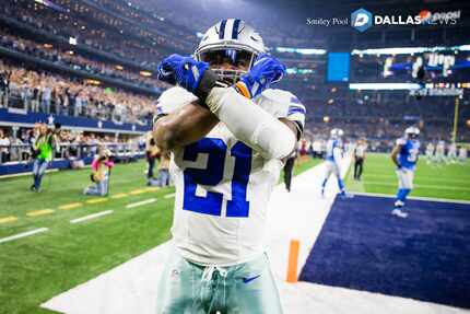 Dallas Cowboys running back Ezekiel Elliott celebrates after scoring on a 55-yard touchdown...