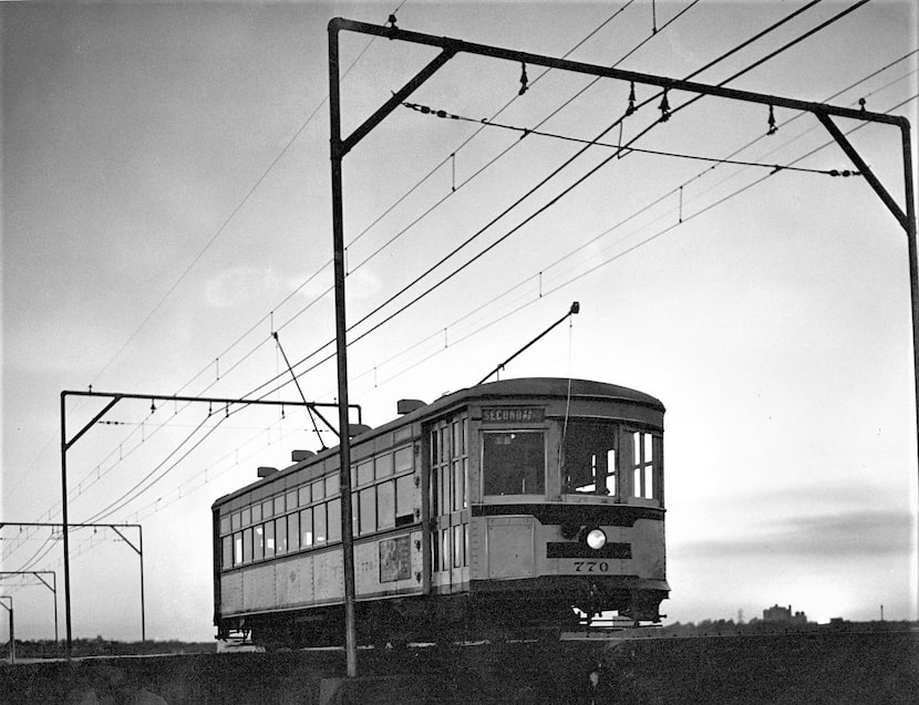 A streetcar comes over the Trinity River trestle as the sun goes down on a Saturday night in...