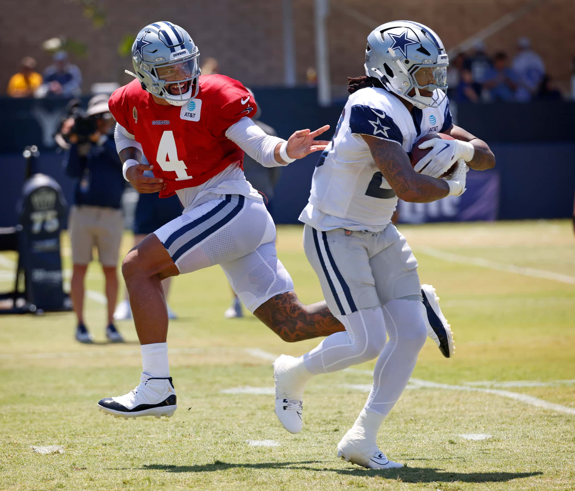 Dallas Cowboys quarterback Dak Prescott (4) hands the football off to running back Rico...
