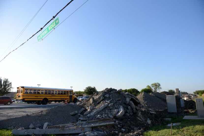 
Cars travel along Murphy Road Aug. 25 amid road construction near McMillan High School and...