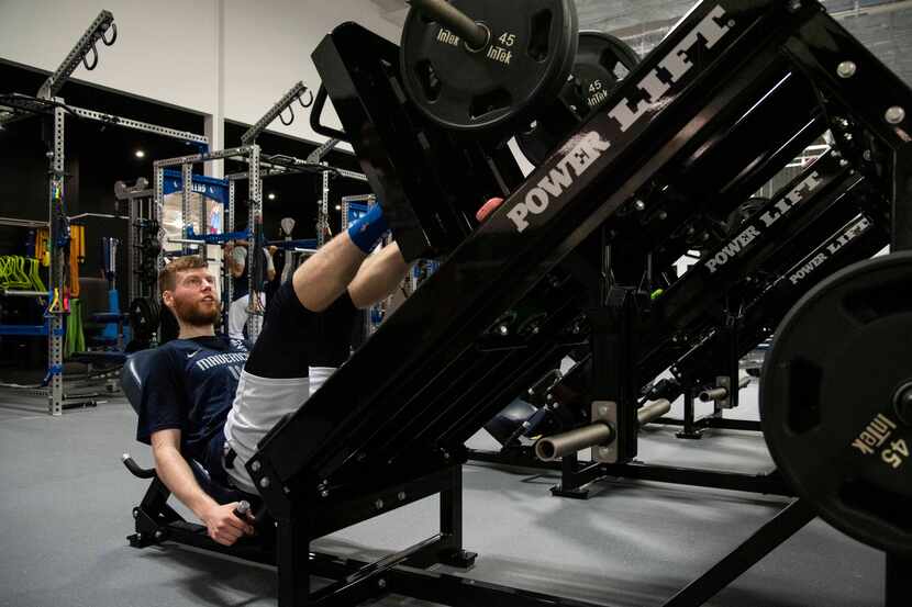 Dallas Mavericks shooting forward Davis Bertans (44) uses the leg press in the weight room...