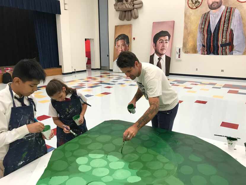 Artist Roger Peet works with students Alan Diaz and Azalae Custodio on Wednesday, August 22...