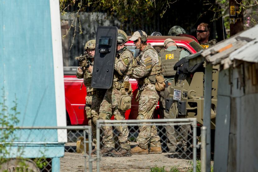 FBI agents approached the home of the Austin bombing suspect in Pflugerville on Wednesday.