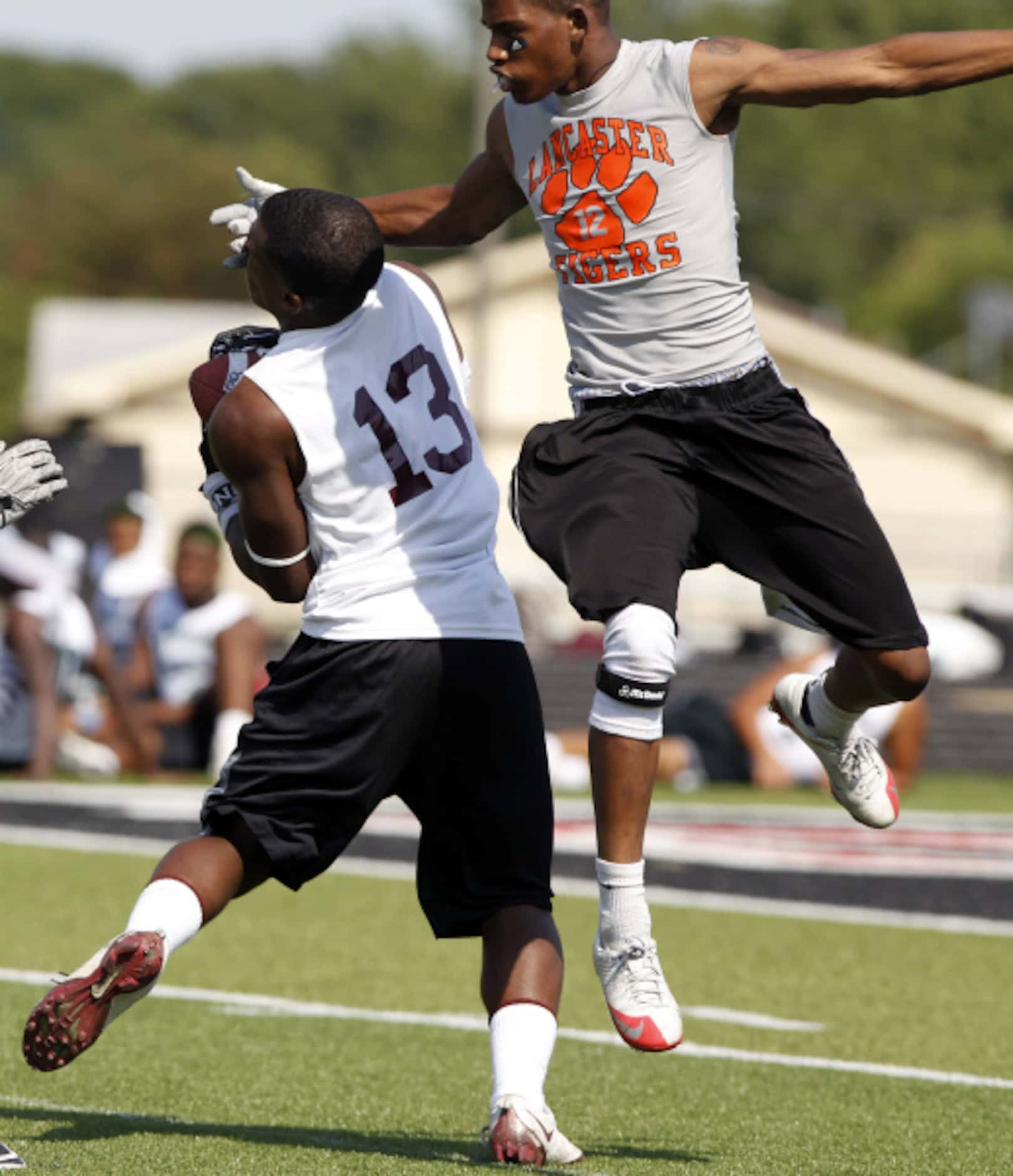 Plano receiver Lj Ausama (13, right) catches an arm in the face by Lancaster defender...