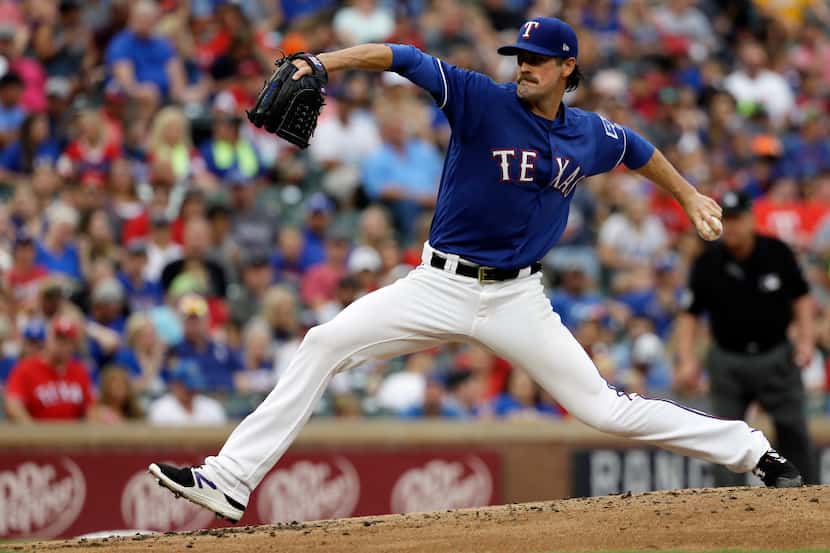 Texas Rangers starting pitcher Cole Hamels throws to the Los Angeles Angels in the second...