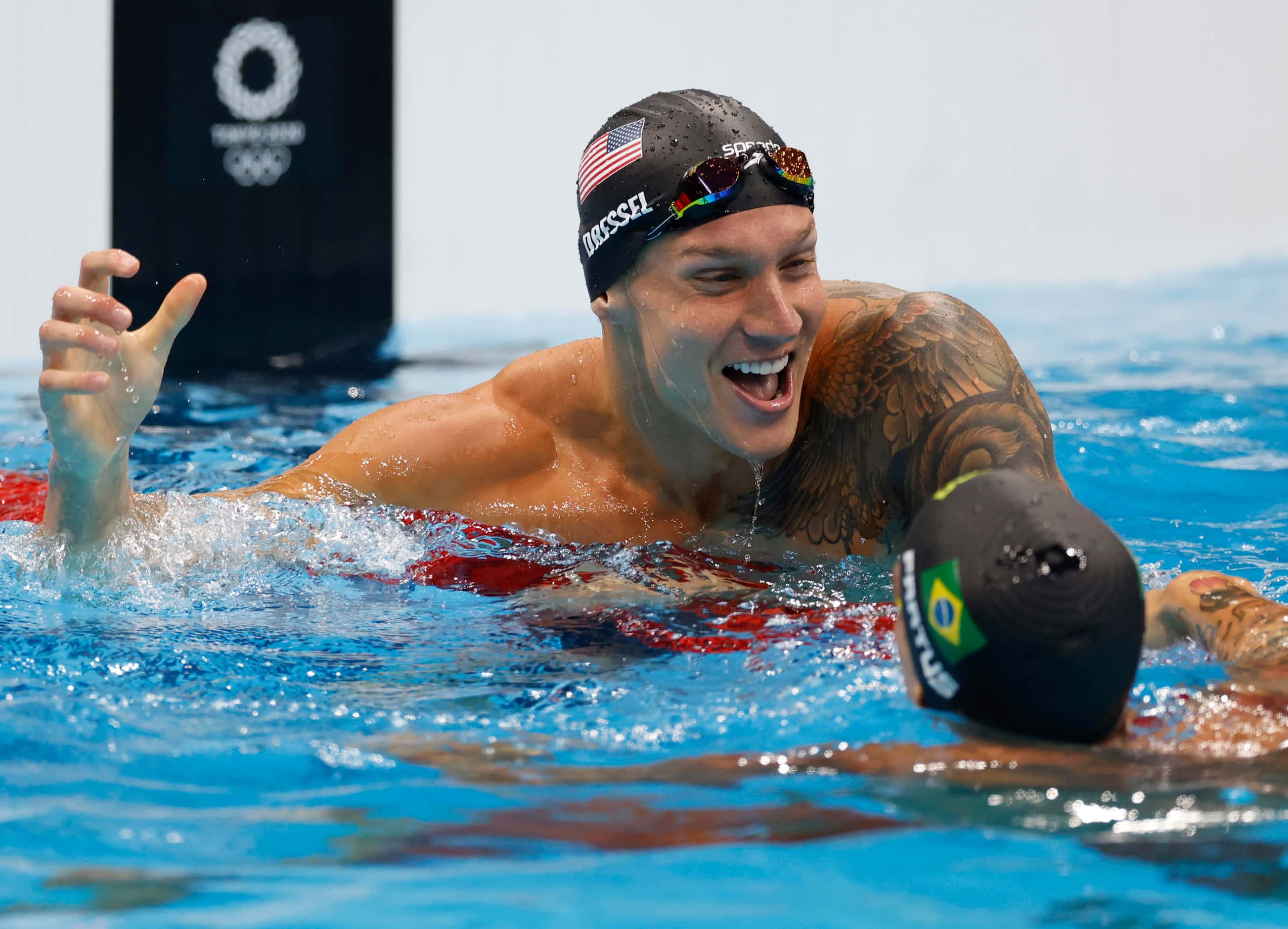 USA’s Caeleb Dressel celebrates with Brazil’s Bruno Fratus after winning the men’s 50 meter...