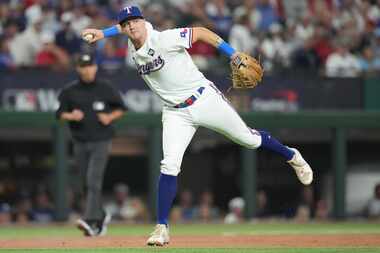 Texas Rangers third baseman Josh Jung fields an infield single by Arizona Diamondbacks...