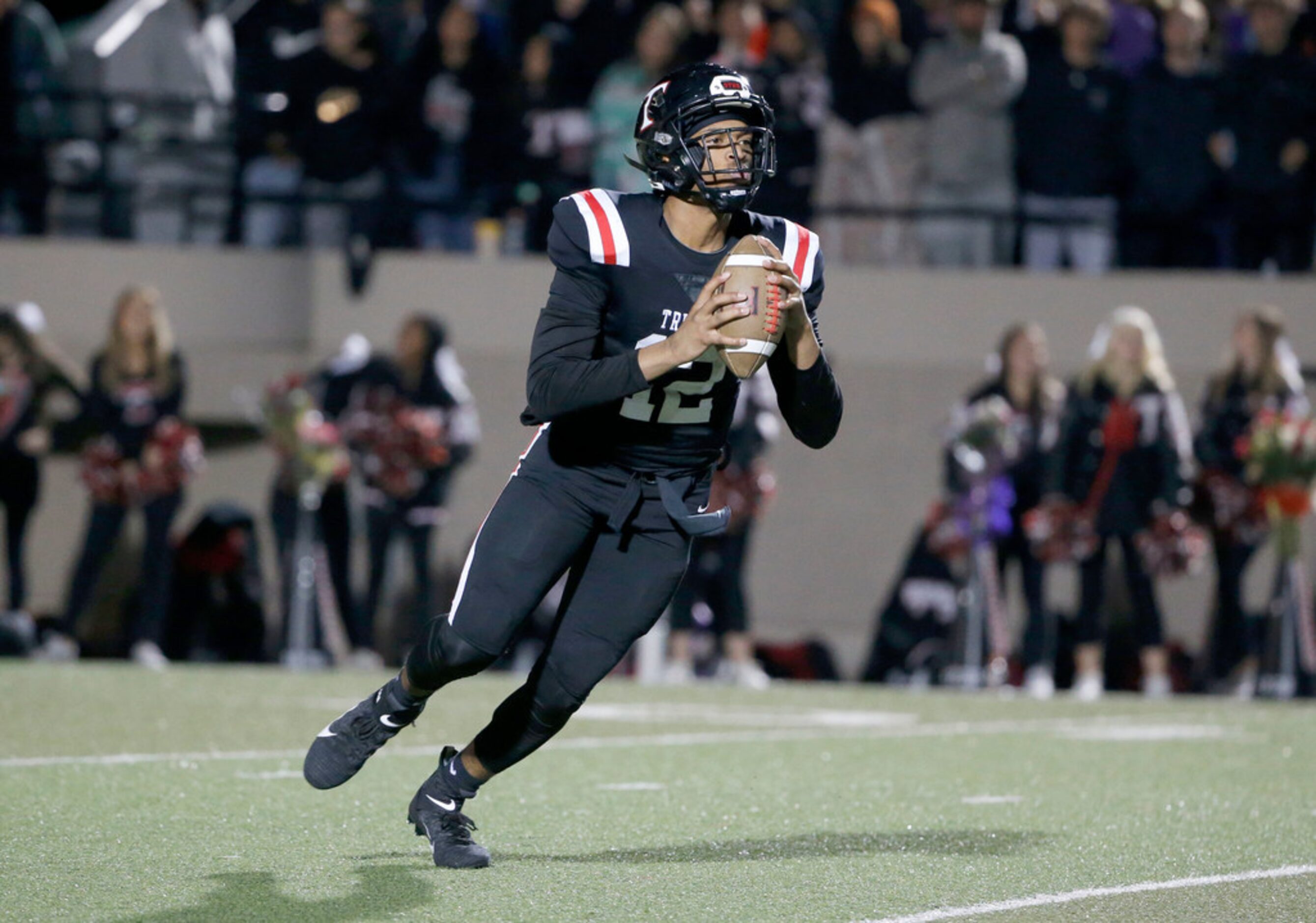 Euless Trinity quarterback Marcus 
Ervin (12) prepares to throw a touchdown pass against...