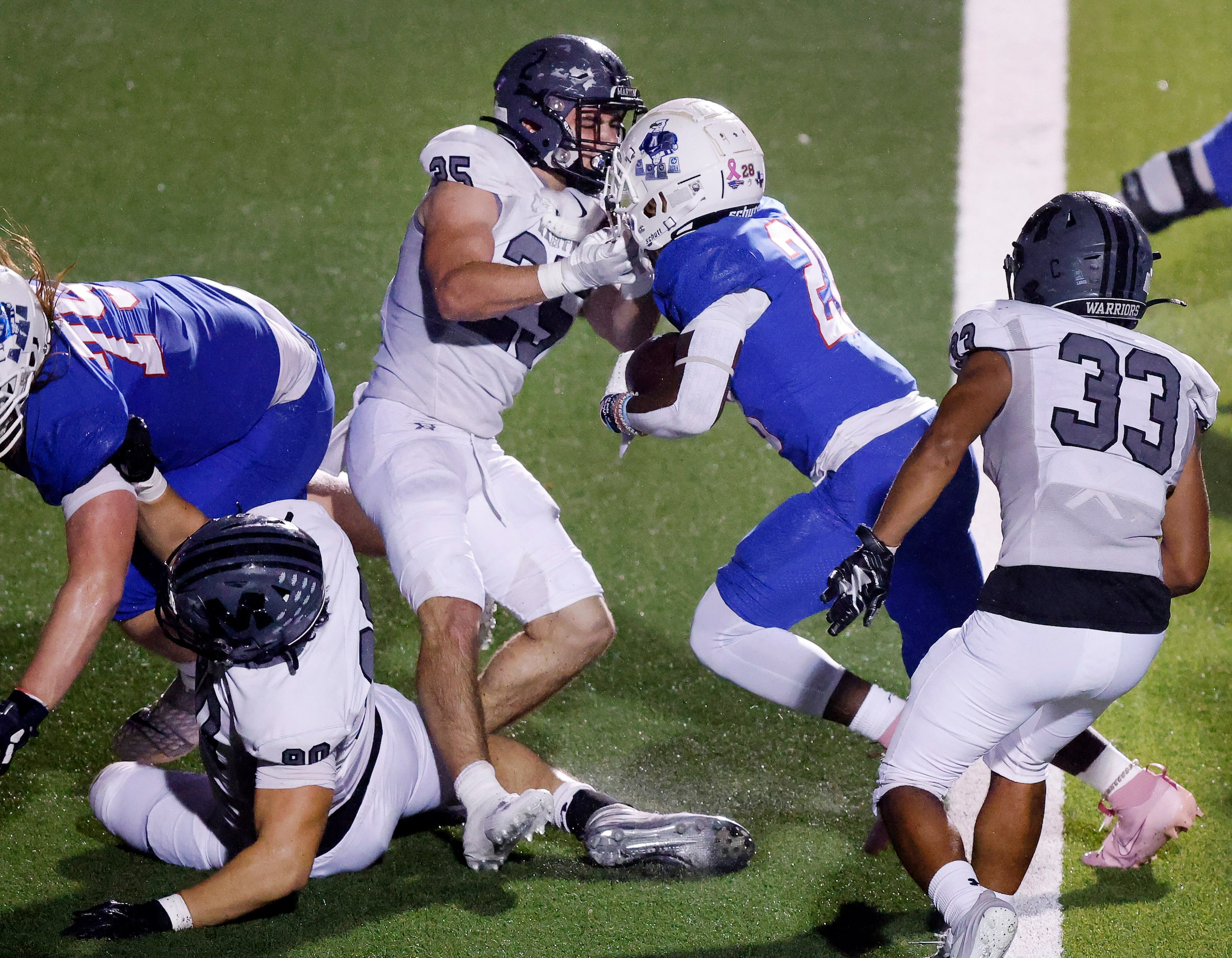 Allen running back Amir McDowell (28) bowls over Arlington Martin defensive back D'Juan...