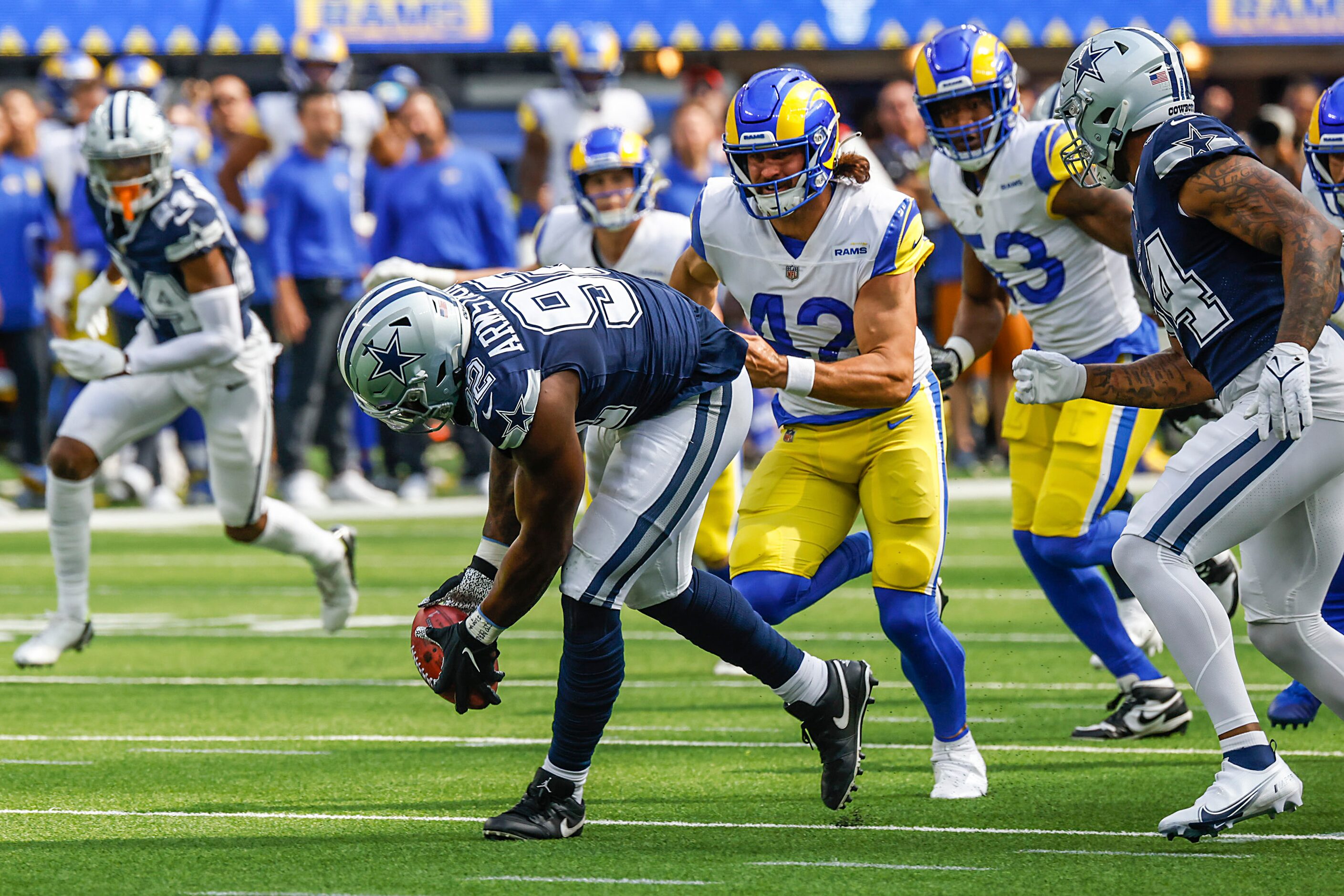 Dallas Cowboys defensive end Dorance Armstrong (92) scoops up the ball after blocking a punt...