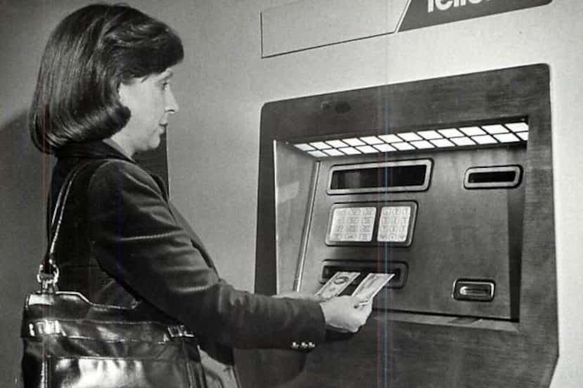 Fredlyn Trull Conant demonstrates the use of a Teller 24 ATM. Photo undated.